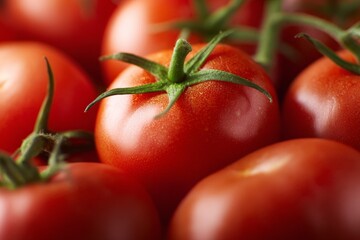 Fresh ripe tomatoes with green stems in a close-up view