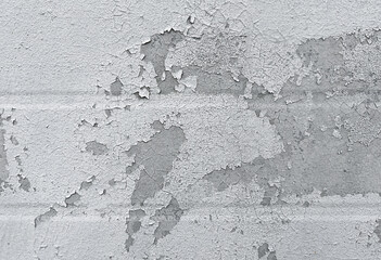 Peeling flaking paint on gray concrete wall. Cracked coating texture background. Dirty grunge surface backdrop. Repair concept.