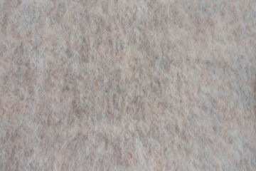 High resolution macro of wool polyester blend fabric in soft beige tones. Visible fuzzy texture and natural fibers. Suitable for textile backgrounds, fashion, material design and surface patterns.