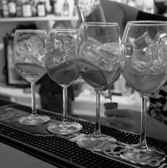 various glasses and dishes on the bar stock you can see hands human drinks beauty hand movements in the distance bottles name not visible rasofkus in the distance