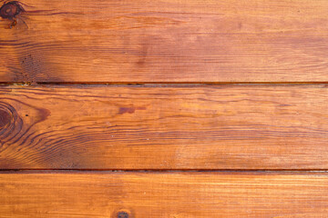 Wooden surface with rich texture and warm tones in natural lighting creates an inviting atmosphere for various activities