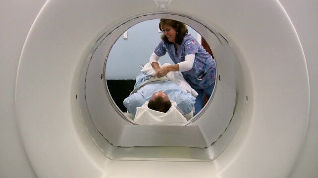 PET Scan Technologist Positioning Patient into PET CT Scanner
