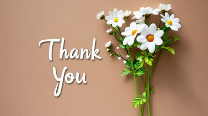 A bouquet of white flowers with the words "Thank You" written below them