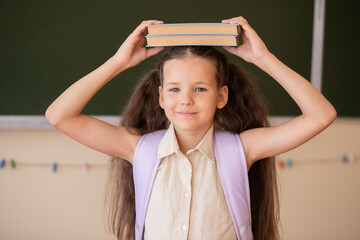 Excitement Fills the Air as a Schoolgirl Prepares for Her First Day Back to Class, Balancing Books...