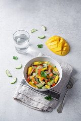Cucumber red onion mango red bell pepper salad in a bowl