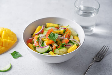 Cucumber red onion mango red bell pepper salad in a bowl