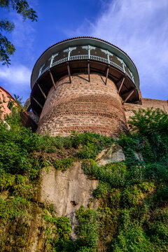 Distinctive round tower of Queen Darejan's 18th-century palace complex in Tbilisi, Georgia. The structure showcases traditional Georgian architecture with decorative balconies atop ancient stonework