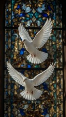 Two white doves in flight against a colorful stained glass background.