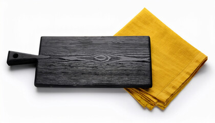 Black wooden cutting board with textured grain detail placed on a folded mustard yellow cloth, isolated on a white background. Modern, rustic kitchen accessory for food styling or cooking.