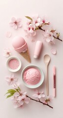 Pink ice cream scoops, blossom sprigs, a tube, salt, and lip products arranged aesthetically on a pink background