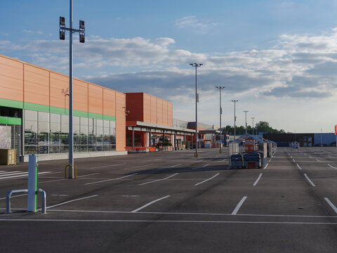 Modern commercial retail building with empty parking lot during early morning or evening hours