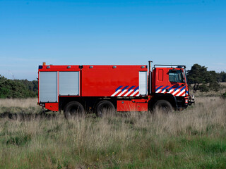 Side profile of Dutch fire truck with distinctive livery showing equipment storage compartments in...