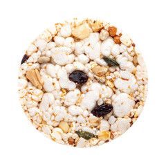 Circular rice cereal snack with dried fruit seeds nuts and seeds in a close-up view on a plain white background