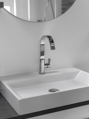 Contemporary white ceramic basin with chrome faucet in minimalist bathroom design