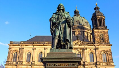 Fototapeta premium Bronze statue in front of a church
