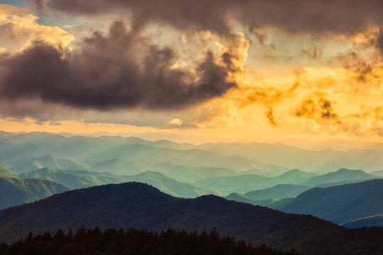 A dramatic cloudy landscape at sunset of the famous Blue Ridge Mountains with misty layers by Ashville, North Carolina in the United States