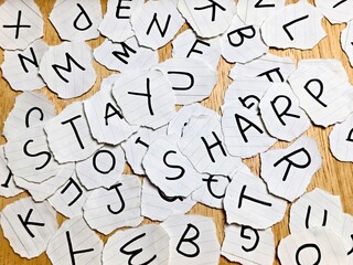 Scattered Alphabet Torn Paper Letters on Wood Stay Sharp Message Education Concept.