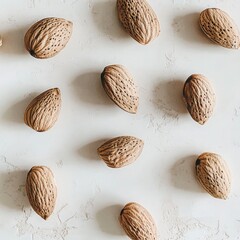 Overhead View of Almonds Arranged on Textured White Surface