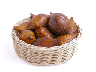 Fresh snakefruit on a wicker bowl isolated on white background, buah salak, salacca zalacca,...