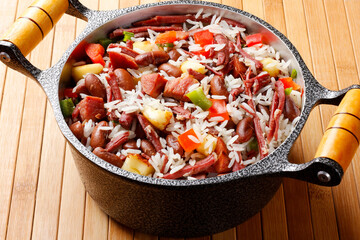 Baião de Dois in a rustic pot, a typical dish of Brazilian northeastern cuisine with rice, beans, jerked beef and curd cheese