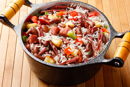 Bai&atilde;o de Dois in a rustic pot, a typical dish of Brazilian northeastern cuisine with rice, beans, jerked beef and curd cheese