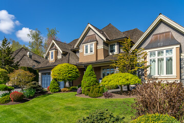 Two story stucco luxury house with nice spring blossom landscape in Vancouver, Canada, North...
