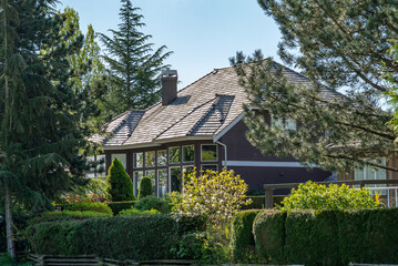 Two story stucco luxury house with nice spring blossom landscape in Vancouver, Canada, North America. Day time on May 2025.