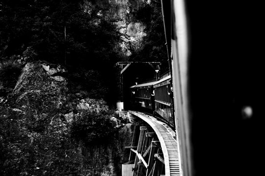 Historic Train Crossing Wooden Trestle Toward Tunnel in Alaska