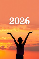 Girl with arms raised against orange sunset sky with 2026