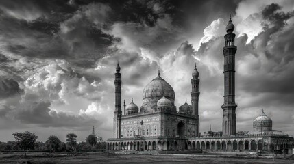 Monochrome photo features a grand mosque beneath a dramatic, cloudy sky