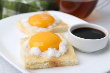 Tasty kaya toasts with half-boiled eggs served on table, closeup. Traditional asian breakfast