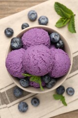 Tasty sorbet with blueberries and mint in bowl on table, top view