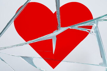 Betrayal. Broken glass with red heart, top view