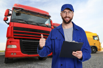 Car service worker with clipboard and truck outdoors