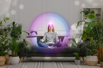Woman meditating in Lotus pose at home. Bright bubble around her representing aura