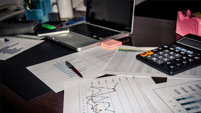 Business team analyzing financial data and marketing charts using graphs on office desk - Powered by Adobe