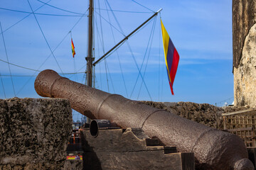 Old cannon protecting the walls of Cartagena de Indias with colombian flag