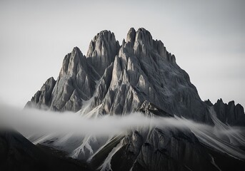 Dramatic mountain peak shrouded in ethereal mist under a monochrome sky breathtaking scenery