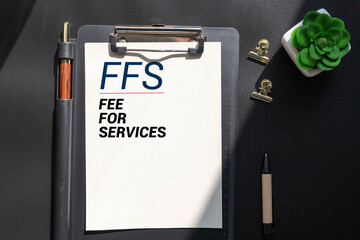 The word FFS written on wood cube. Business concept, Fee for services.