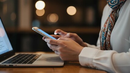 Woman using smartphone and laptop in a modern setting - Powered by Adobe