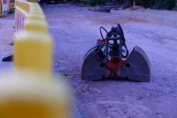 Road Work Zone with Plastic Fences and Excavator Bucket