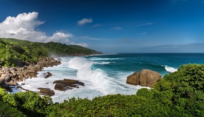 a rocky coastline with crashing waves and foamy surf against a backdrop of lush greenery