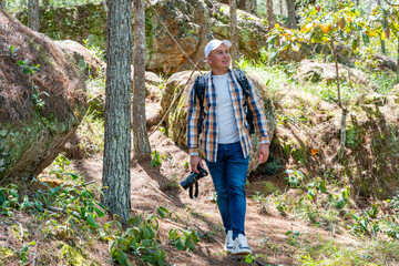 Serene photographer looking up in peaceful pine forest