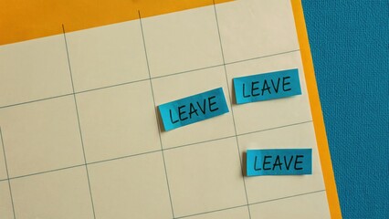 Marking time off on a calendar with bright blue 'Leave' sticky notes, planning important breaks.