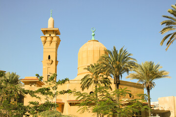 A wide daytime view of Abd El Rahman Lotfy Shabara Mosque, showcasing its full Andalusian architecture and surroundings near the Suez Canal