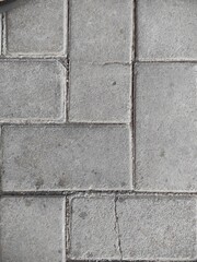 Obraz premium Durable grey concrete paving stones offer a textured, modern backdrop for urban design projects