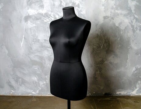 Black mannequin against textured wall