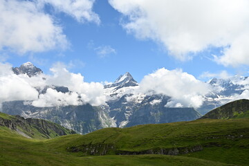 Fototapeta premium Snow-covered alpine peak with clouds in the Bernese Oberland