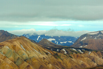 Stunning view of Iceland's rugged mountains and snow-capped peaks under moody skies