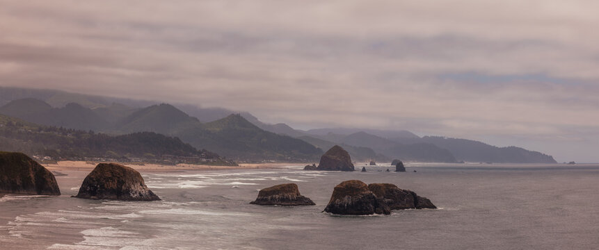 Views of the Canon beach and Oregon coastline vistas from Ecola State Park in the misty morning time.
